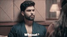 a man with a beard is talking to a woman and the words whaaat are visible