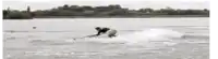 a person is riding a wave on a surfboard in the water .
