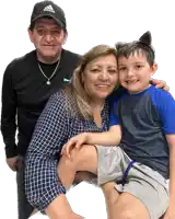 a man wearing an adidas hat holds a woman and child
