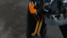 a close up of a person wearing a black and orange jumpsuit