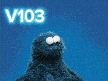 a cookie monster holding a red heart with the words lovew above him