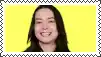 a close up of a woman 's face with a yellow background and a frame around it .