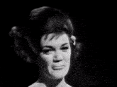 a woman singing in a black and white photo