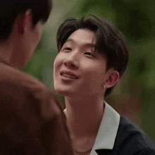 a close up of a man 's face while looking at another man 's face .