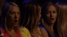 a group of women sitting in a dark room with a abc logo on the bottom right