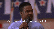 a man speaking into a microphone with the words get your hand out of my pocket written below him