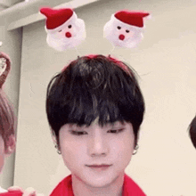 a close up of a person wearing a christmas headband .