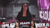 a female wrestler is standing in front of a sign that says raw tonight