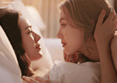two women laying on a bed looking at each other with the caption lingermoifss