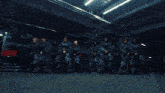 a woman in a black crop top is standing in front of a crowd of people
