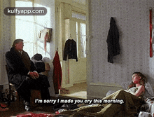 a man is sitting in a chair talking to a woman who is laying on a bed .
