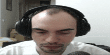 a man wearing headphones and a white shirt