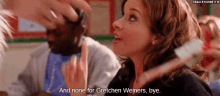 a woman is holding a toothbrush in her hand and saying `` and none for gretchen weiners , bye .