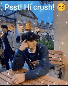 a man sitting at a table with the words psst hi crush written above him