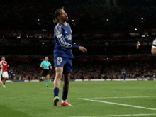 a soccer player with the number 29 on his shorts stands on the field