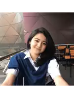 a young girl wearing a blue sweater and white shirt smiles for the camera