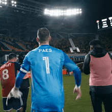 a soccer player wearing a blue jersey with the number 1 on the back