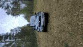 a car is parked on a dirt road in the woods .