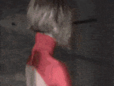 a woman in a red superhero costume is standing in a hallway