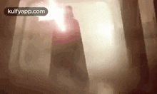 a man in a cape is standing in a dark room with smoke coming out of the ceiling .