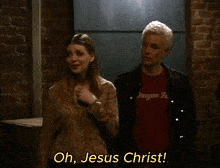 a man and a woman are standing next to each other and the man is wearing a dragon inc shirt