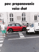 a red car is parked on the side of the road in front of a white van