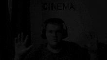 a man wearing headphones with the word cinema above him