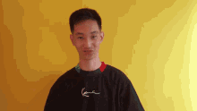 a young man wearing a black shirt with karl kani on it