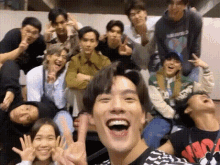 a group of people are posing for a picture together and laughing .