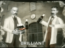 two men are standing next to each other holding bottles of beer in a room .
