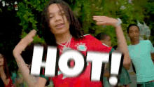 a young man in a red shirt says hot