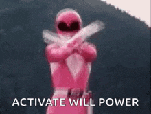 a pink power ranger is standing in front of a mountain holding two guns .