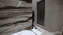 a woman stands in a bathroom with the words made in animotica on the bottom