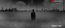 a black and white photo of a man standing in a field with the caption terbaik
