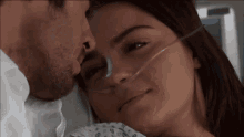 a man is kissing a woman with an oxygen mask on her face