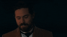 a man with a beard and a quote that says love is not just an emotion