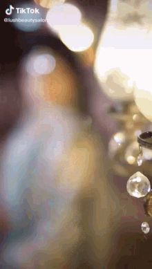 a blurred image of a chandelier with a tiktok logo in the corner