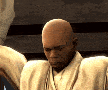 a bald man in a white robe is looking down