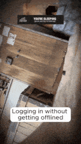 a sign that says ' you 're sleeping ' on top of a wooden table