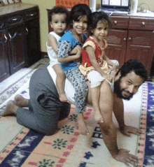 a man is kneeling down with three children on his shoulders and the word police is on the rug in the background
