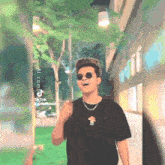 a man wearing sunglasses and a black t-shirt with a mushroom on the front