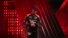 a man in a racing suit with the number 31 on his shirt