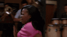a blurry picture of a woman screaming in a room with a bookshelf in the background