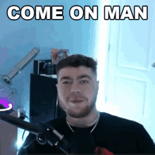a man in front of a microphone with the words come on man written above him