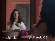 a woman looking at herself in a mirror with the hashtag lialmeida05 below her