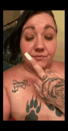 a woman has a tattoo on her chest that says " ambrose "