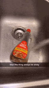 a bottle of pearl milling butter rich syrup is sitting in a sink
