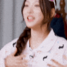 a close up of a woman 's chest with her hands on her chest and her mouth open .