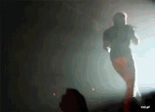 a gif of a man walking on a stage with the words rbd.gif below him