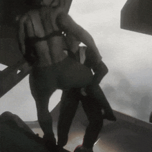a man is carrying a woman in his arms
